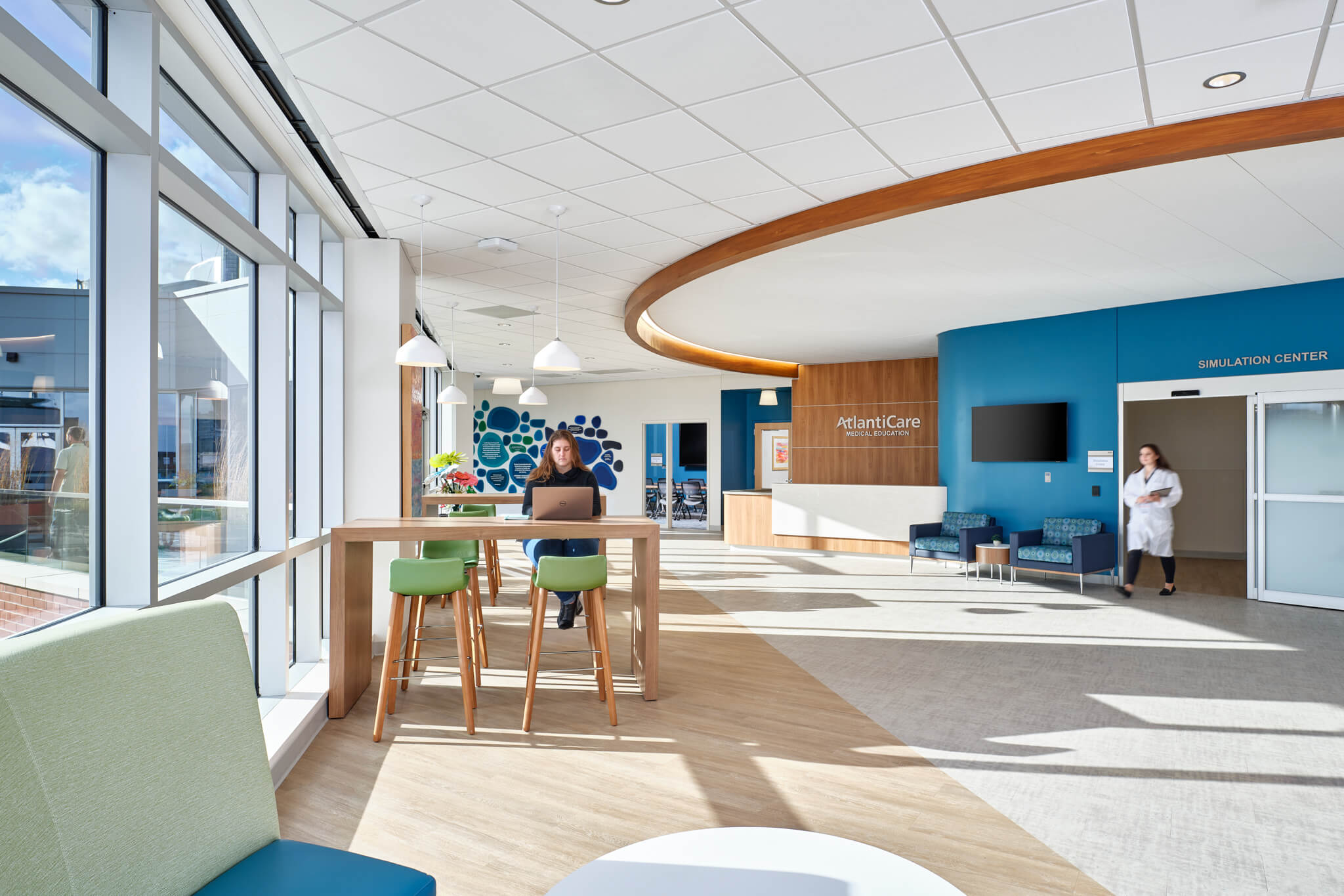 A healthcare lobby with a spacious table and a large window providing natural light.
