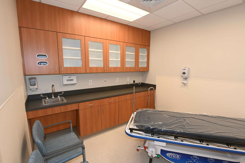 Healthcare office exam room with rolling bed